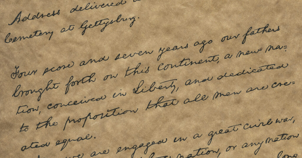 Written text of the Gettysburg Address on a dark paper background